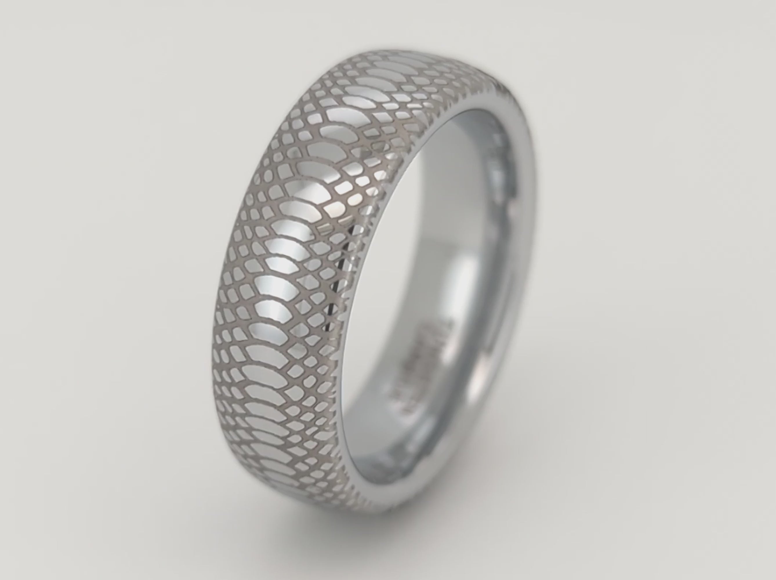 Serpente Eterno tungsten ring with intricate snake scale texture, polished silver finish, filmed on clean white background. Unique tungsten carbide jewelry for men and women.