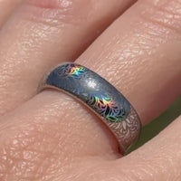 Video preview of the Glowing Reverie tungsten ring showing the holographic effect shifting in the light.