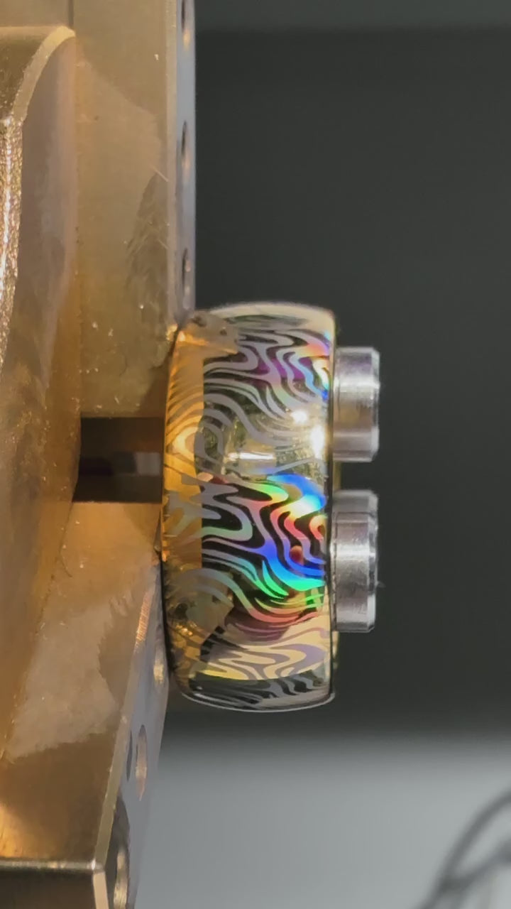 Video preview of the Mokume Radiance tungsten ring showing the holographic effect shifting in the light.