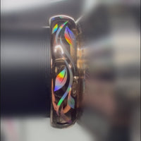 Close-up video of a Botanic Glow ring on a metal holder, showing rainbow reflections across its leaf-inspired lines.