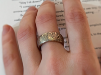Fluidic Essence tungsten ring with laser-engraved surface detail, worn on a hand.