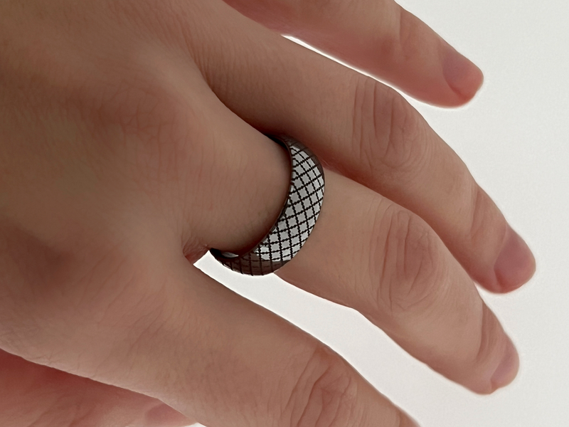 White Gold Quilted Elegance tungsten ring with laser-engraved surface detail, worn on a hand.